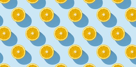 Cut half of orange on a blue background. Minimalism. Concept of tropics, healthy eating, vitamins....