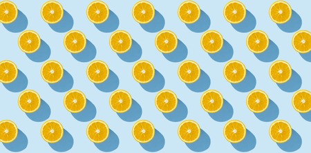 Cut half of orange on a blue background. Minimalism. Concept of tropics, healthy eating, vitamins....