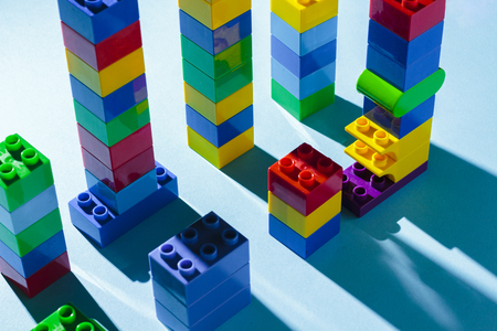 Columns from the children's designer on a blue background. The concept of building houses, new building. Flat lay, top viewの写真素材