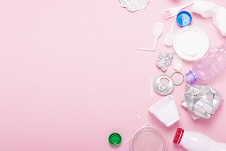 Garbage collection, plastic and metal on a pink background. Concept stop plastic, recycling,...