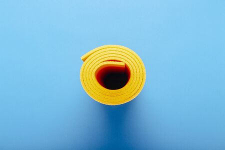Yoga mat, Karimat on a blue background. The concept of yoga, yoga for beginners, stretching.の写真素材