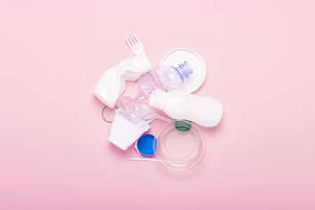 Garbage collection, plastic on a pink background. Concept stop plastic, recycling, separate...
