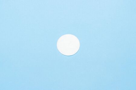 Cotton hygienic disc for makeup on a blue background. Makeup and hygiene concept. Flat lay, top view.の写真素材