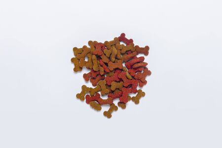 dry pet food in bowl on white background top view