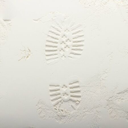 Footprint from a boot on a gray stone background. Moon surface texture. First step. Flat lay, top...