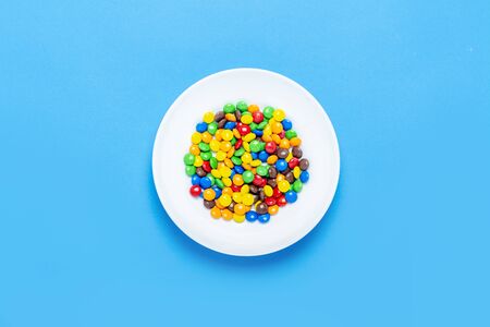 Colorful candies background, copy space. Nuts in multi-colored glaze dragee. Sweet candies spreading pastry decoration. Pile of colorful coated candy. Sweets texture, pattern. Top view, flat layの写真素材