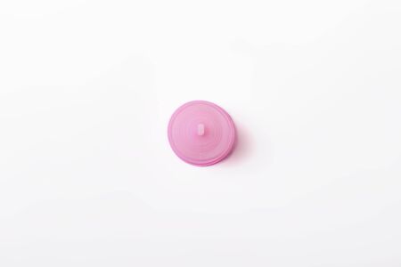 Pink menstrual cup on a white background. The concept of menstruation, the choice between feminine hygiene products. Flat lay, top.の写真素材