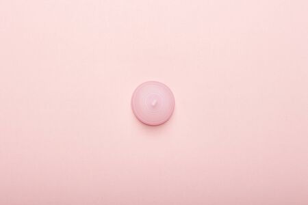 Menstrual cup on a pink background. The concept of menstruation. Flat lay, top.の写真素材