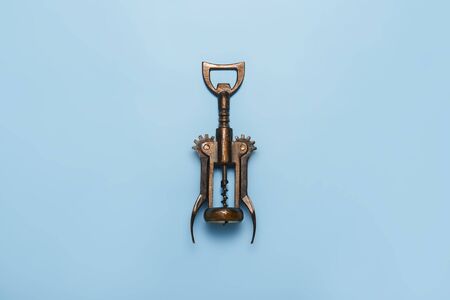 Metal retro corkscrew on a blue background. Flat lay, top view.の写真素材