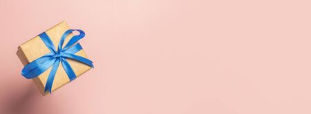 Flying gift on a pink background. Gift concept for a loved one, holiday, christmas. Levitation....
