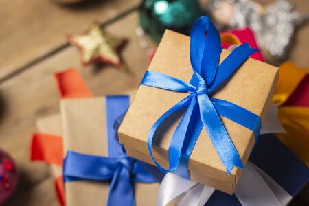 Stack of gifts, Christmas-tree decorations on a wooden background. Holiday concept, christmas, christmas eve. Flat lay, top view.の写真素材