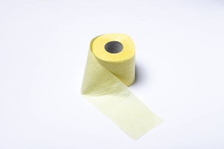 Roll of yellow toilet paper on a white background. Personal hygiene concept. Flat lay, top view.の写真素材