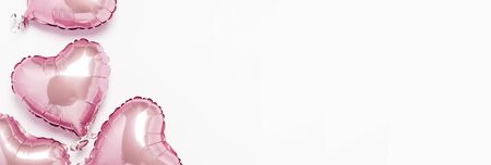 Pink air balloons heart shape on a white background. Concept wedding, valentines day, photo zone, lovers. Banner. Flat lay, top view.の写真素材