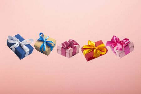 Gifts flying in the air on a pink background. Concept gift for a loved one, birthday, Valentine's...