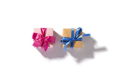 Two gifts, blue and pink gift on a white background. Natural light with a hard shadow. Holiday concept, gift. Flat lay, top view.の写真素材