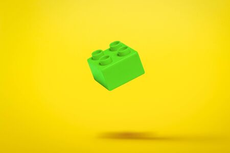 Detail of a toy constructor flying in the air on a yellow background. Levitation. Logic concept, kids toys. Flat lay, top view.の写真素材