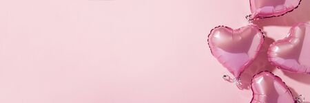 Air balloons heart shape on a pink background. Natural light. Banner. Concept love, wedding, photo zone. Flat lay, top view.の写真素材