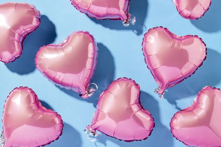 Air balloons heart shape on a blue background. Natural light. Banner. Concept love, wedding, photo zone. Flat lay, top view.の写真素材