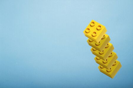 Details of a toy constructor fly in the air against a blue background. Levitation. Logic concept, kids toys. Flat lay, top view.の写真素材