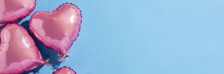 Air balloons heart shape on a blue background. Natural light. Banner. Concept love, wedding, photo zone. Flat lay, top view.の写真素材