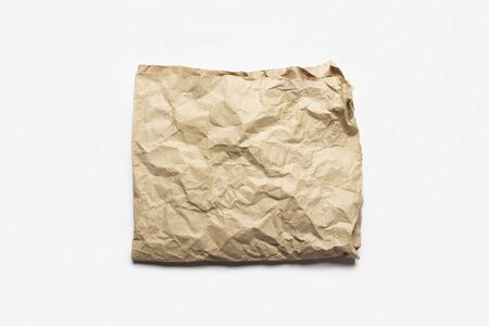piece of crumpled craft paper on a white background. Texture, banner. Can be used as background. Top view, flat lay.の写真素材