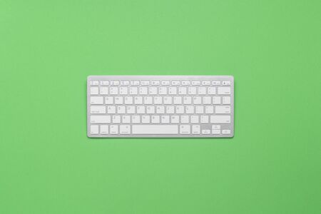 Keyboard on a green background. Business concept, writer, freelance, journalist. Flat lay, top viewの写真素材