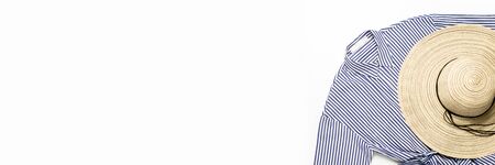 Beautiful female summer hat and dress on a white background. Copy space, flat, lay. Banner.