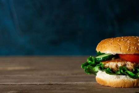 Fresh appetizing tasty burger with beef on a wooden table.