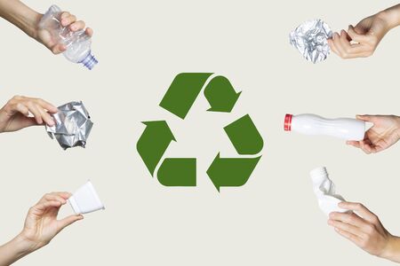 Hands hold trash on a light background. Recycling sign. The concept of separate trash, stop plastic, recycling.の写真素材