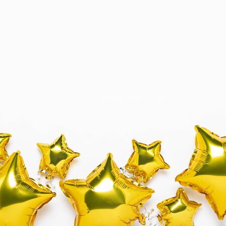 Air golden balloons star shape and candy on a white background. Concept for holiday, party, photo zone, decoration. Banner Flat lay, top view.の写真素材