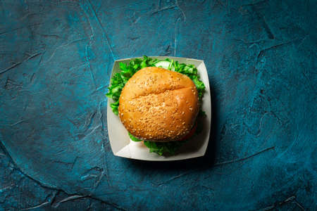 Fresh burger on a blue concrete background. Flat lay, top view.の写真素材