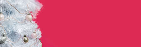 White tree decorated with decorative toys on a burgundy background. Empty space for text. Celebration of winter, New Year, Christmas. Banner.の写真素材