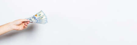 Female hand holds money on a white isolated background. Concept is rich, wealth, buy, pay, tax....