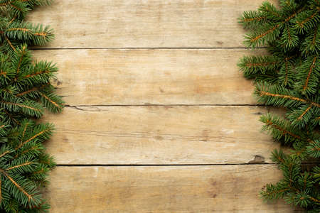 Wooden background with Christmas tree branches and snow. Christmas concept. Banner. Flat lay, top...