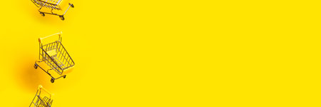 flying three empty trolleys on a bright yellow background. Bannerの写真素材