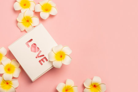 Gift box and flowers on a pastel pink background. Composition Valentine's Day. Flat lay, top view. Banner.の写真素材