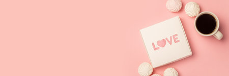 Gift box, cup with coffee, meringue and sweets on a pink background. Composition Valentine's Day. Banner. Flat lay, top view.の写真素材