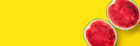 Juicy red watermelon cut in half on a bright yellow background. Bannerの写真素材