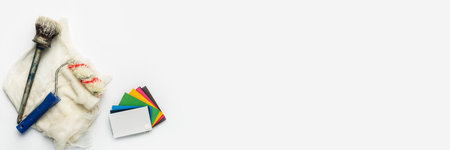 Color palette with shades of paint, paint brushes and rollers on a white background. Banner. Flat lay, top view.の写真素材
