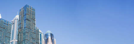 Modern towers or skyscrapers in the financial district at sunny time. Banner