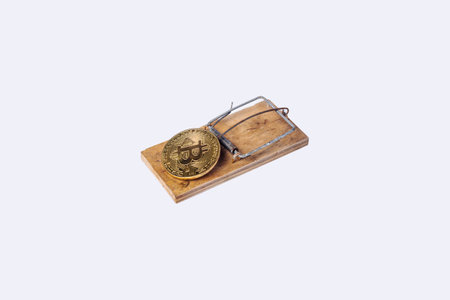 bintcoin coin in a mousetrap on a light background. Top view, flat lay.の写真素材