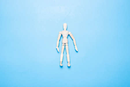 wooden man puppet on a blue background. Top view, flat lay.の写真素材