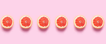 Half grapefruit on a pink background. Pattern. Banner. Flat lay, top view.の写真素材