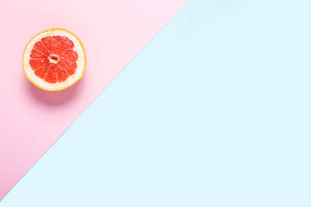 Sliced grapefruit on a pink and blue background. Banner. Flat lay, top view.の写真素材