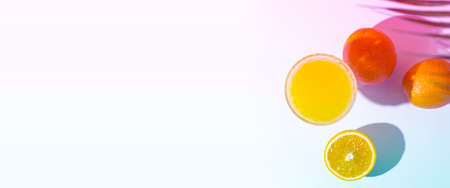 glass with fresh juice, oranges and a leaf of a palm tree on a light background. Added a gradient....