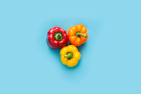 Fresh bright sweet peppers on a blue background. Top view, flat lay.の写真素材
