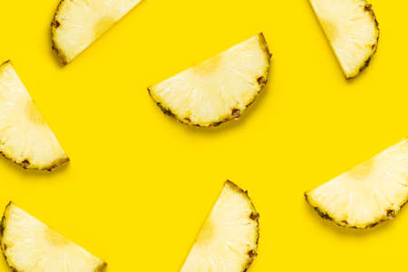 Pineapple slice against on a yellow background. Top view, flat lay.の写真素材