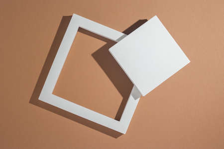 White square podiums for presentations on a brown background. Top view, flat lay.