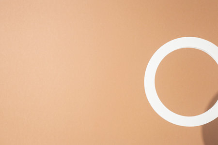 White presentation ring on a light brown background. Top view, flat lay.の写真素材