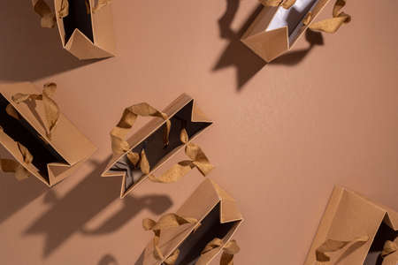 A lot of craft gift packages on a brown background. Top view, flat lay.の写真素材